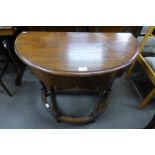 An oak drop-leaf demi-lune hall table