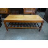 A teak extending coffee table