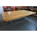 A large hardwood and chrome dining or boardroom table