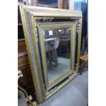 A large Victorian style ebonised and parcel gilt framed mirror, 144 x 112cms