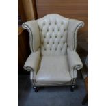 A mahogany and leather wingback armchair