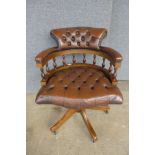 A beech and brown leather revolving desk chair