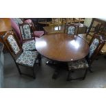 A carved oak extending dining table and four chairs