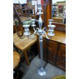 A chrome floor standing candelabra