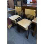 A set of nine ply wood and metal stacking chairs