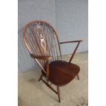 An Ercol Golden Dawn elm and beech fleur de lys armchair