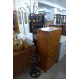 A teak chest of drawers and a metal atomic coat stand, a/f