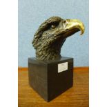 A bronze eagle head, on black marble socle, 21cms h