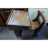 An early 20th Century elm school desk, made by George M. Hammer & Co. Lt., School Furnishers, London