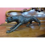 A bronze figure of a crouching leopard, 21cms h x 79cms l