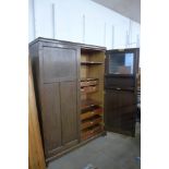 An early 20th Century fitted oak gentlemans two door wardrobe