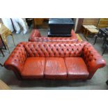 A red leather Chesterfield settee