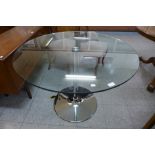 A chrome and glass topped circular table