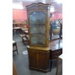 A yew wood freestanding corner cabinet