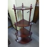 A mahogany four tier corner whatnot