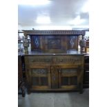 A carved oak court cupboard