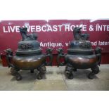 A pair of large oriental bronze two handled koro's and covers, 60cms h