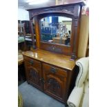 A late Victorian carved walnut mirrorback sideboard