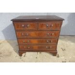 A small inlaid mahogany chest of drawers