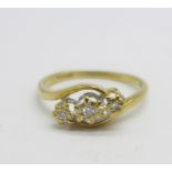 A 9ct gold, three stone diamond ring, 1.9g, M