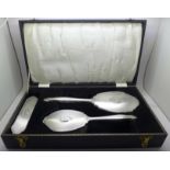 A vintage three piece silver vanity set, hand mirror and two brushes, Birmingham 1963, W I