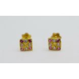 A pair of small red and white stone set ear studs with screw backs, (tops 4mm x 4mm)