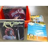 A box of sixty LP records, 12" singles, including Rory Gallagher, Squeeze, Spear of Destiny,