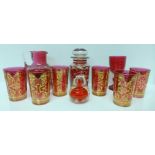 Six Italian glass beakers with gilt decoration, a cranberry glass jug, a glass jar, lid a/f, a glass