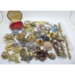 Forty-two costume brooches and a lady's Jules Jerguson wristwatch, boxed