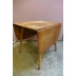 An Ercol Blonde elm and beech drop-leaf table