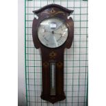 An Arts and Crafts inlaid rosewood aneroid barometer