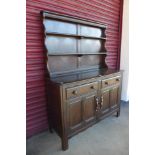 An Ercol dark elm and beech dresser