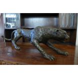 A bronze figure of a crouching leopard, 21cms h x 79cms l