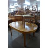 A teak extending dining table and four chairs