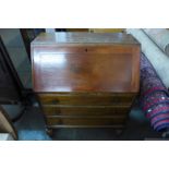 An oak single door display cabinet and an oak bureau