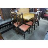 An oak draw-leaf refectory table and four oak chairs