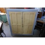 A Victorian pine painted two door cupboard