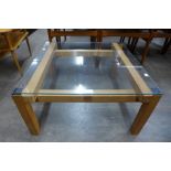 A Farnborough Barn Ltd. teak and glass topped square coffee table, designed by John Makepeace