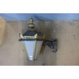 A brass wall lantern with bracket