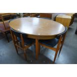 A teak oval extending dining table and four chairs