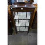 An oak single door bow front display cabinet