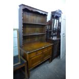 An early 20th Century oak dresser, 191cms h, 107cms w, 52cms d