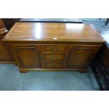A yew wood sideboard and pair of freestanding corner cabinets