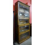 An early 20th Century oak five tier sectional stacking bookcase, 201cms h, 85cms w, 37cms d