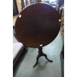 A George III mahogany circular tilt-top tripod table