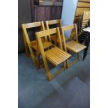 A set of four oak folding chairs
