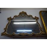 A large French style ebonised and parcel gilt framed mirror, 108 x 150cms