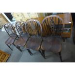 A set of four elm and beech wheelback Windsor kitchen chairs