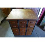 A beech and tubular steel framed bank of fifteen drawers