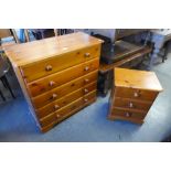 A pine chest of drawers and matching bedside chest